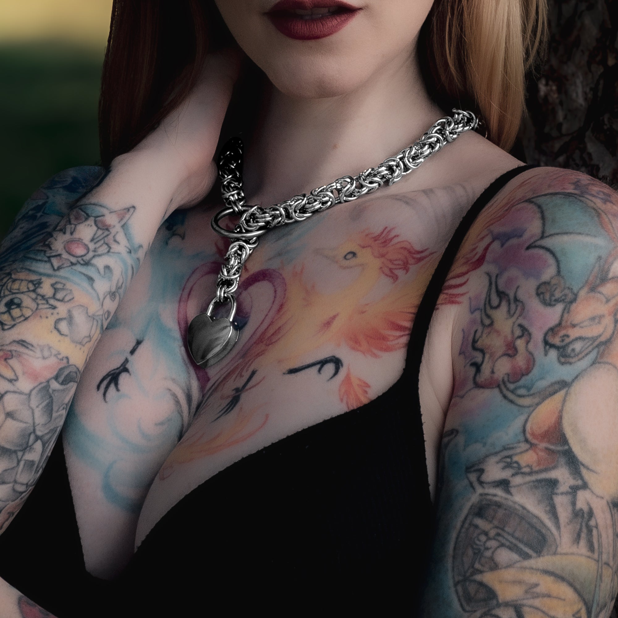 A silver coloured thick and chunky chainmail slip choker with heart shaped padlock