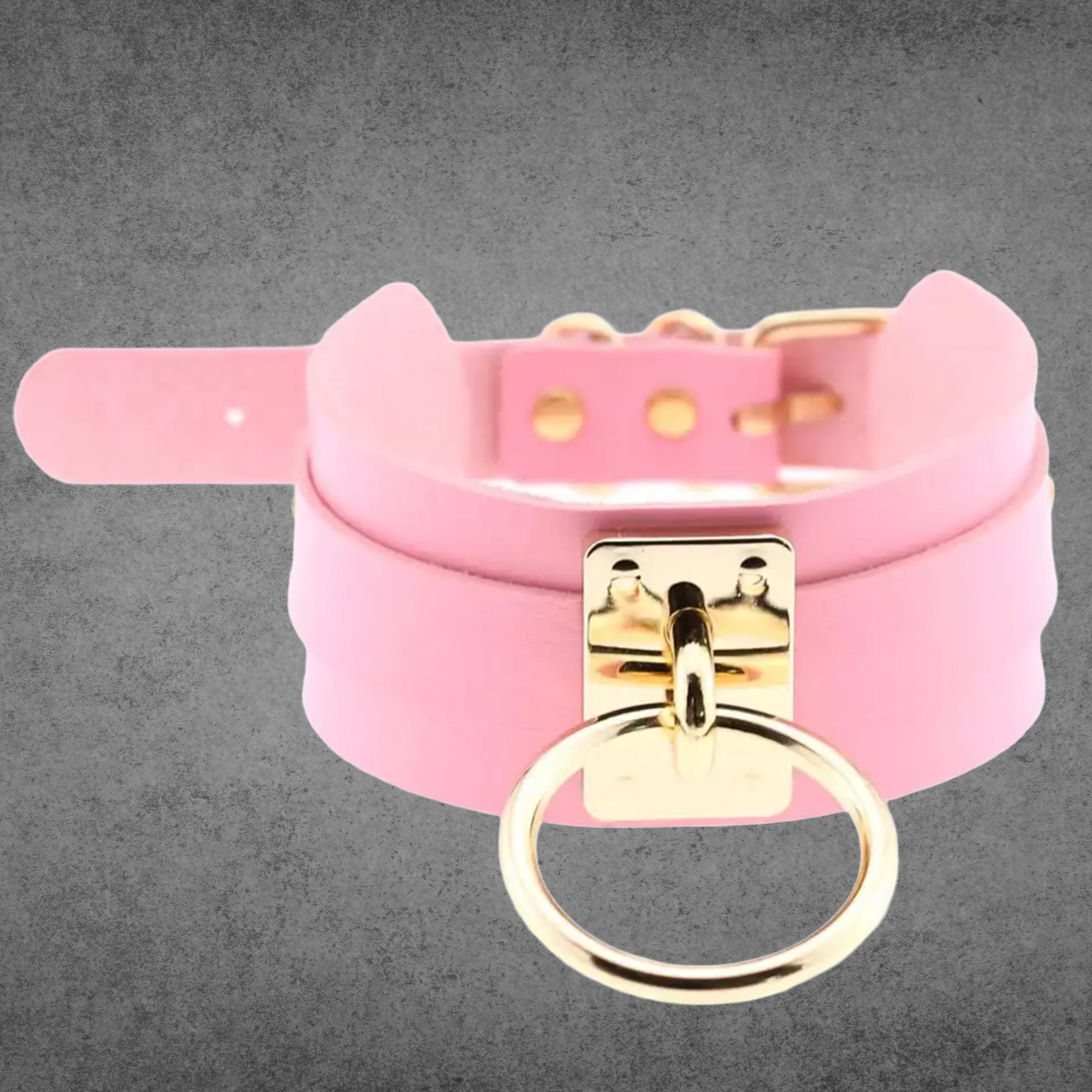 Baby pink faux leather collar with a large gold O-ring centrepiece