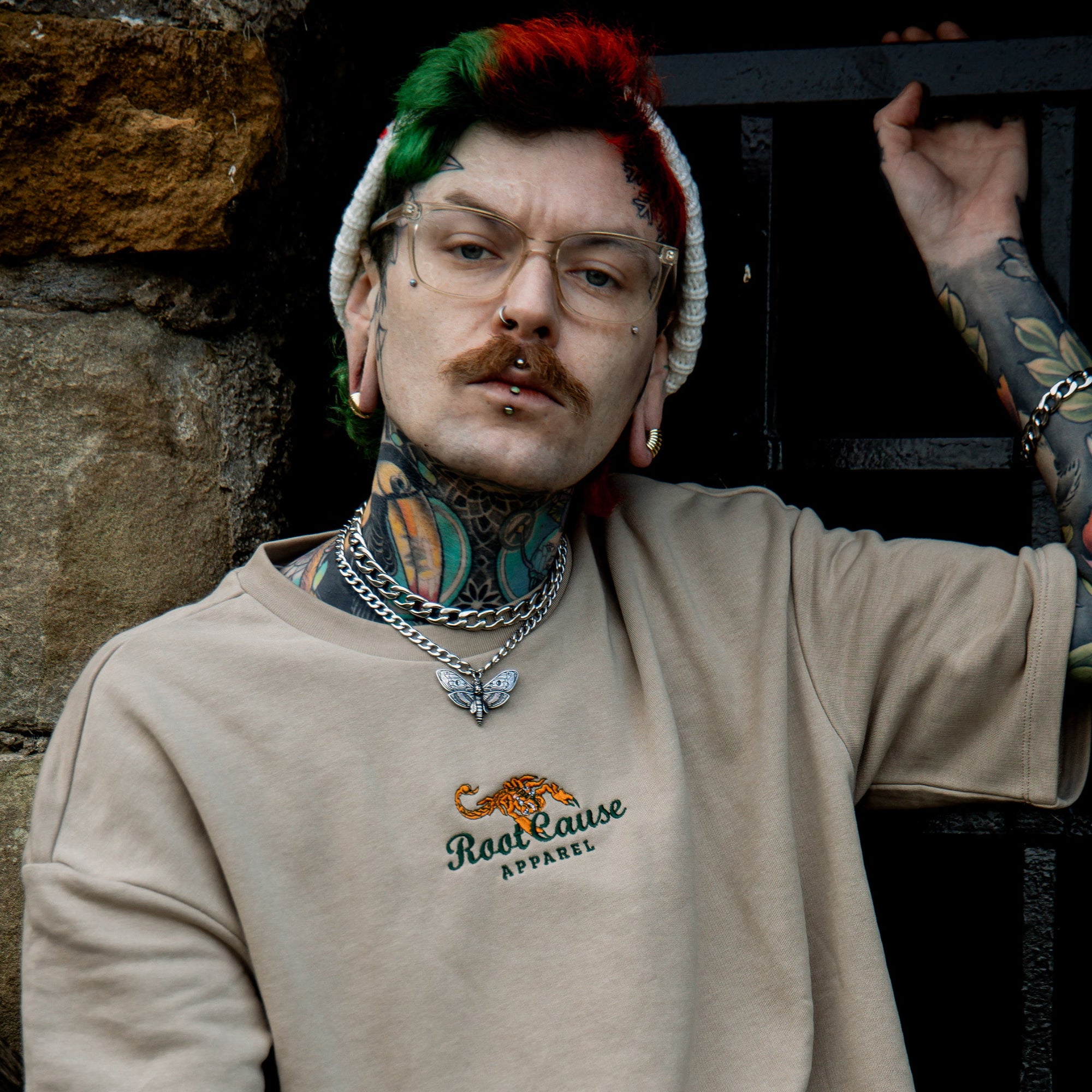 Man wearing a Death Moth Choker with layered silver chunky cuban link choker necklace