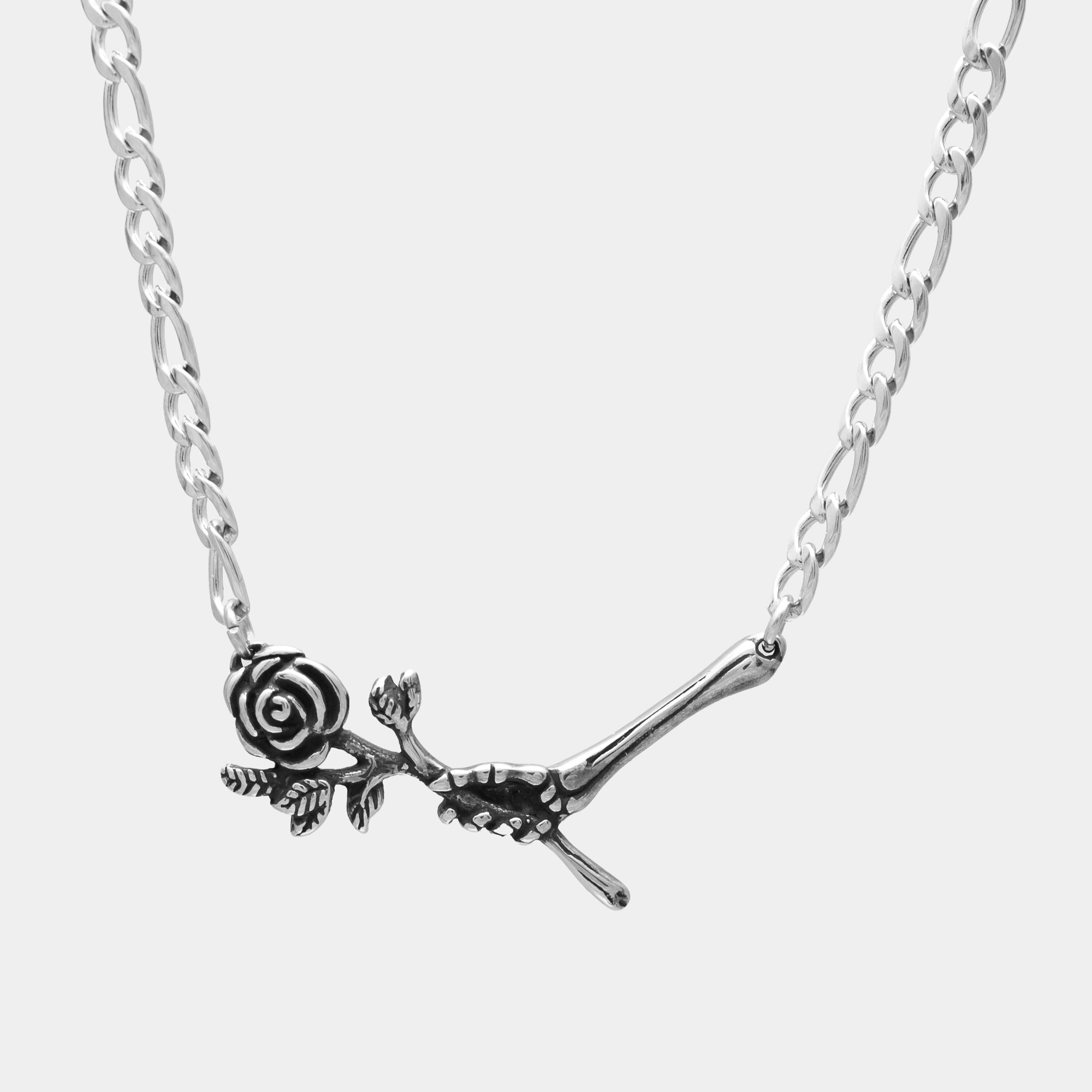 Silver Hand of love pendant featuring a skeleton hand holding a rose on a figaro chain