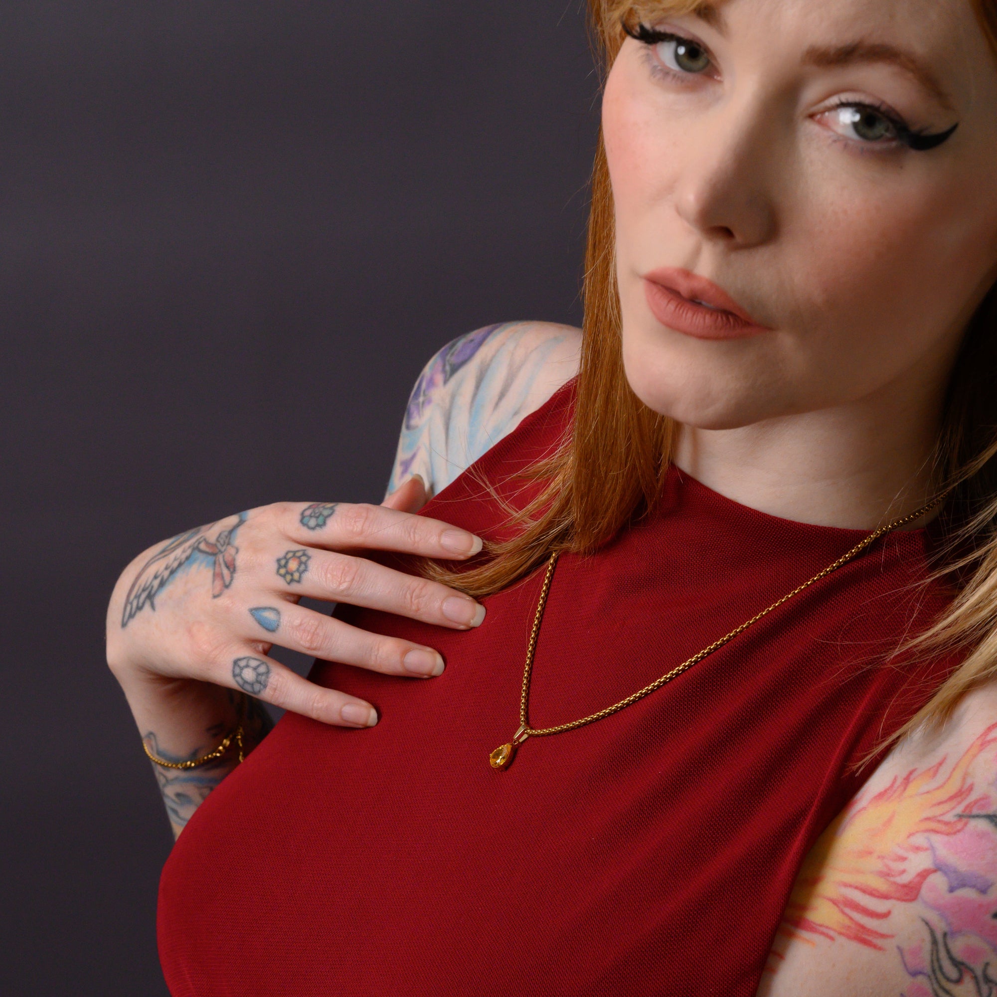 Model wears a citrine November birthstone pear cut pendant necklace in gold