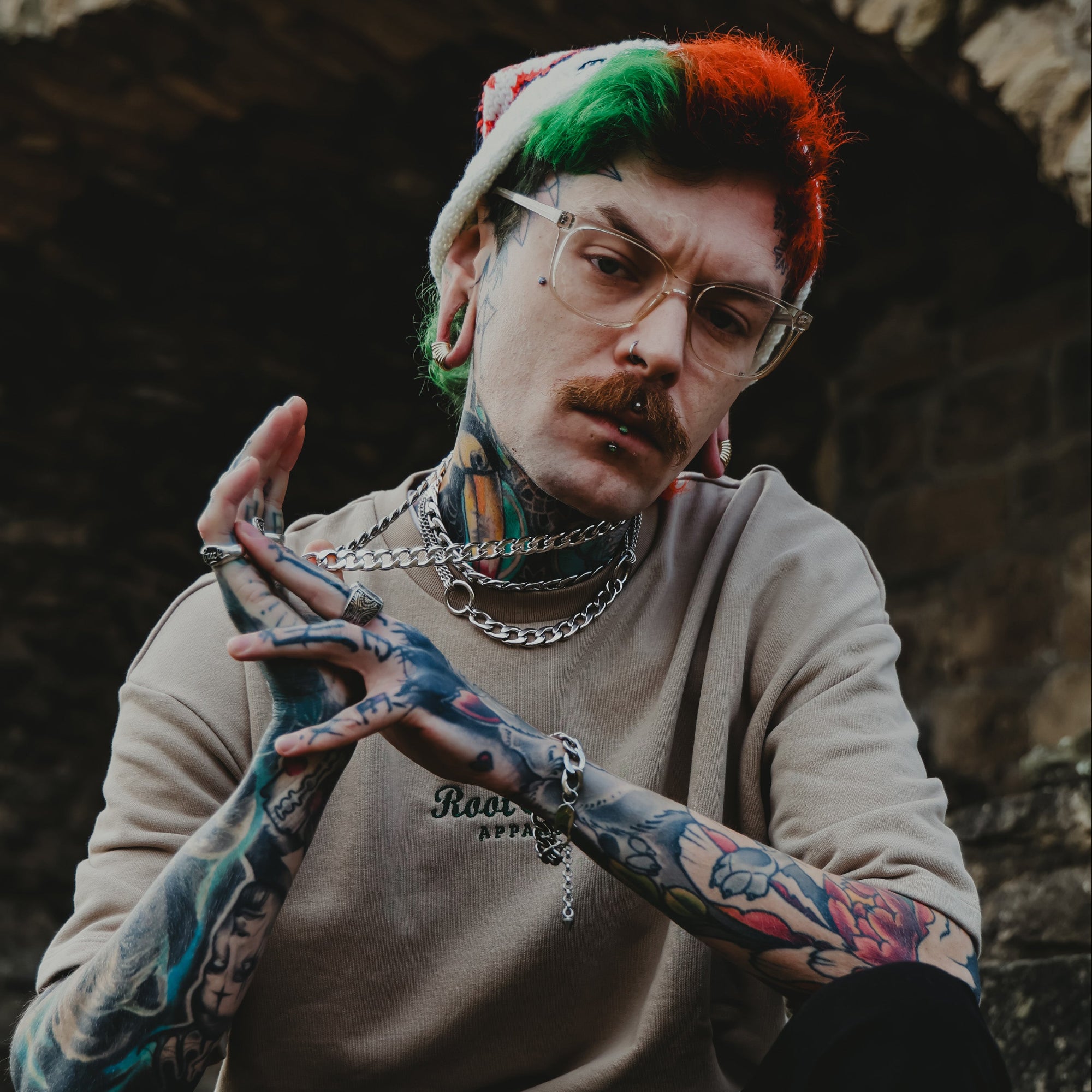 man wears chunky layered cuban link chains featuring a double o ring choker necklace all in silver finish