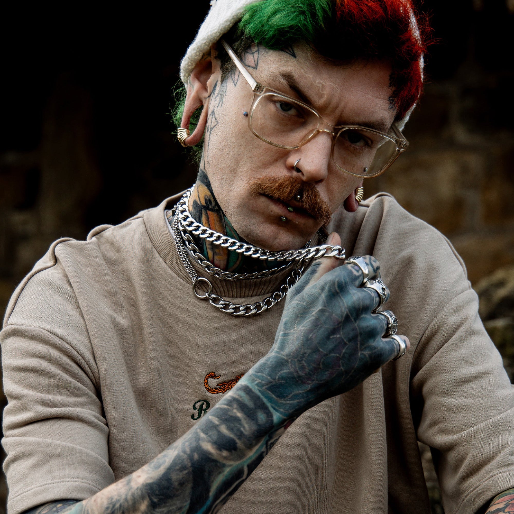 man wears a layered double o ring choker with chunky chains in a silver finish