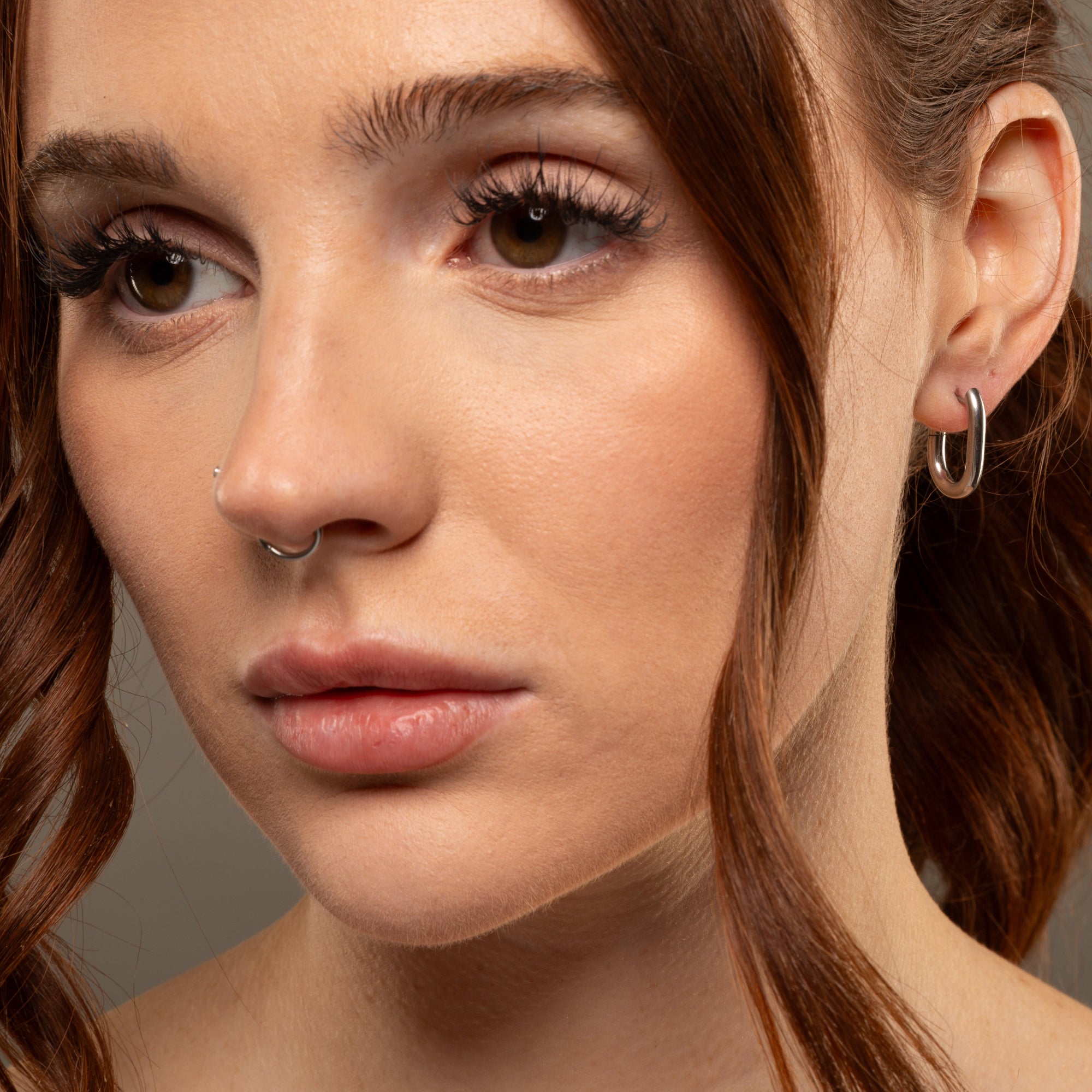 Oval huggie hoop earrings in silver