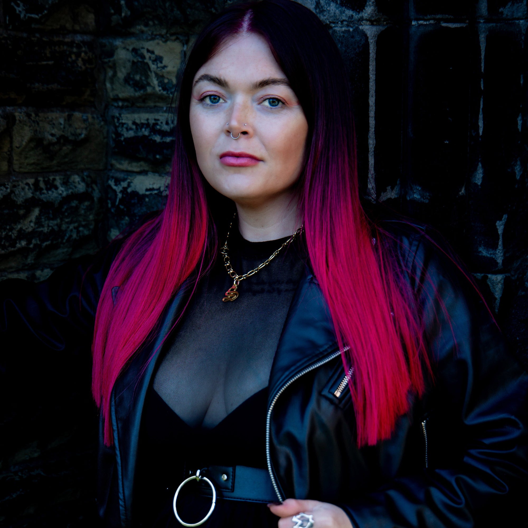 woman wears chunky oval link initial necklace in gold