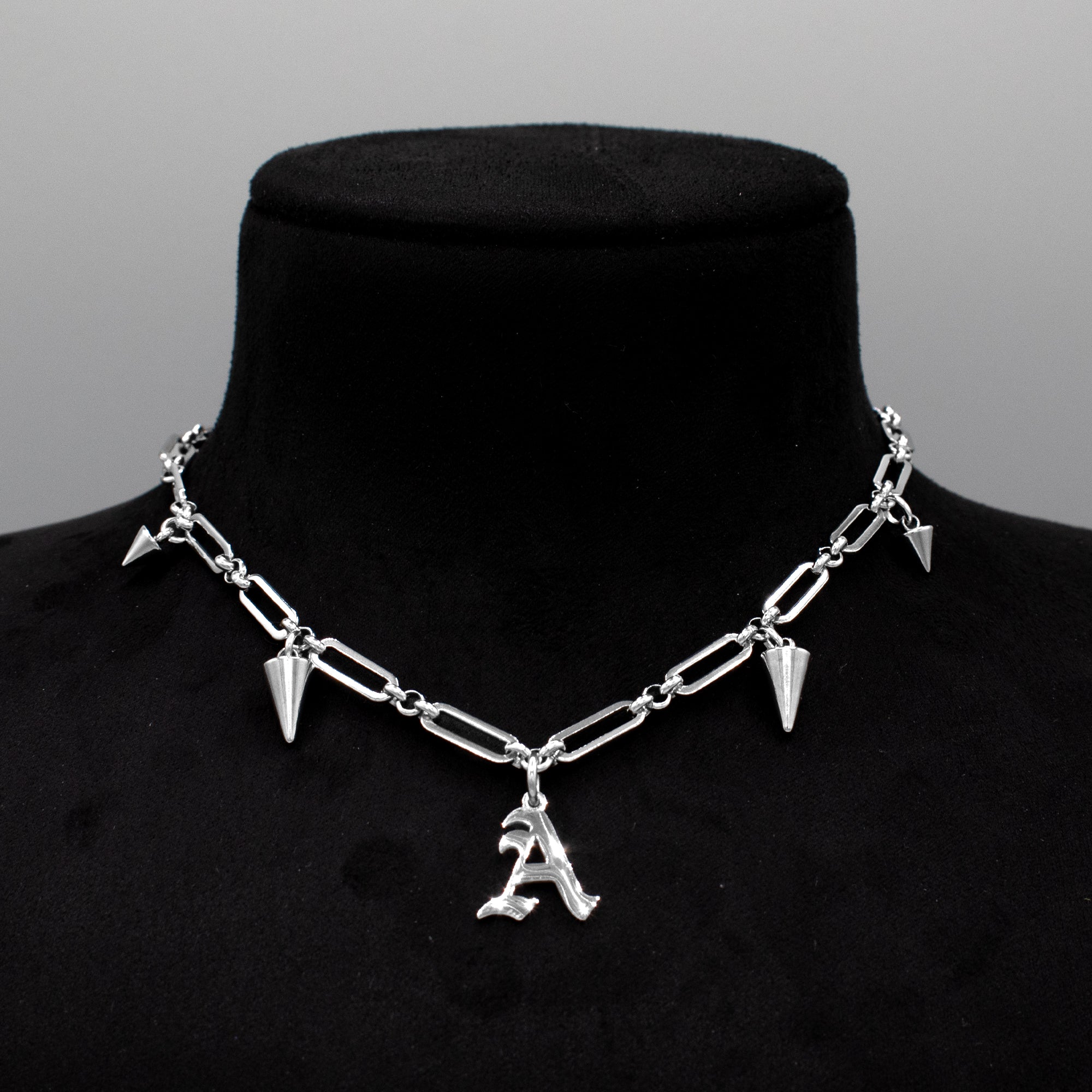 old English Gothic initial spiked choker necklace close up