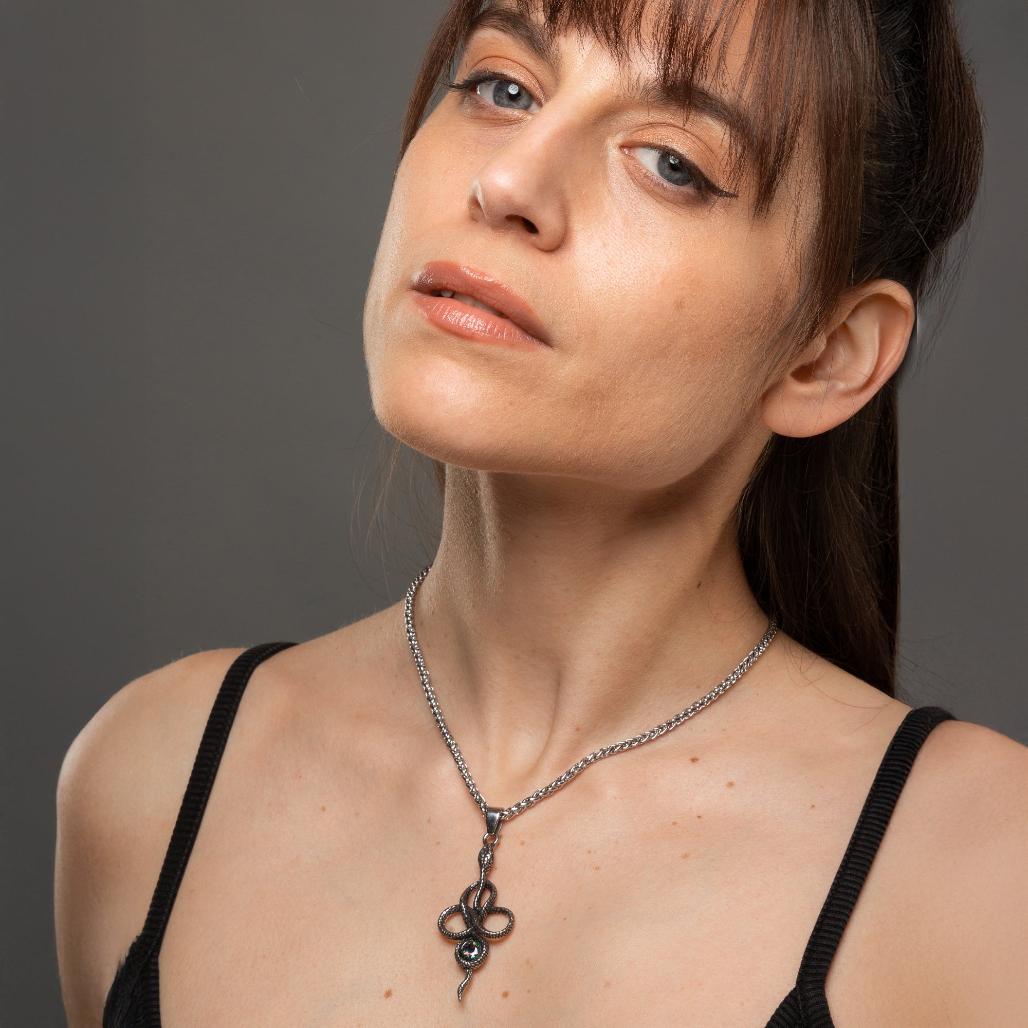 Silver snake pendant featuring a large single colourful cubic zirconia stone on a 3mm foxtail necklace