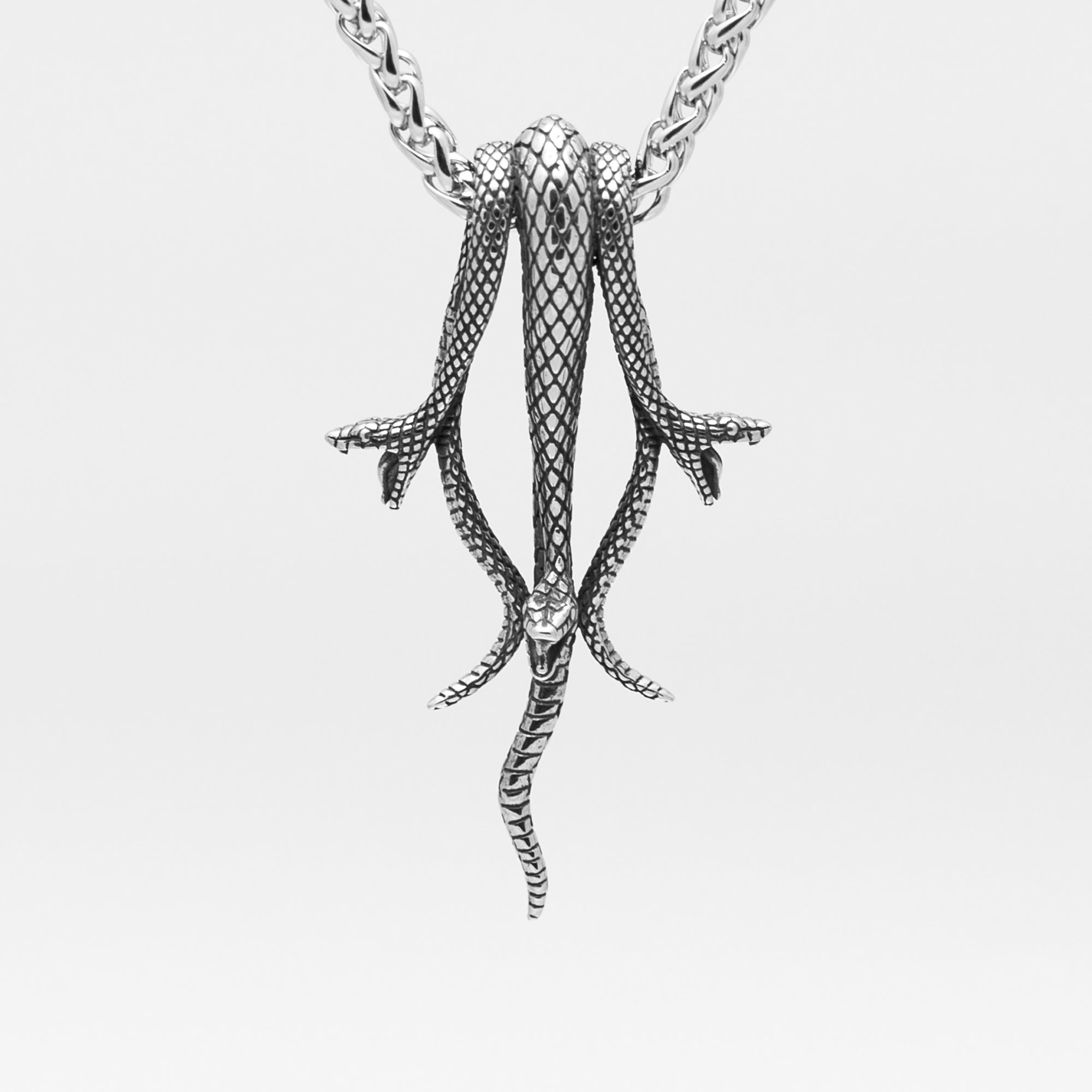 silver gothic style snake pendant featuring 3 snakes