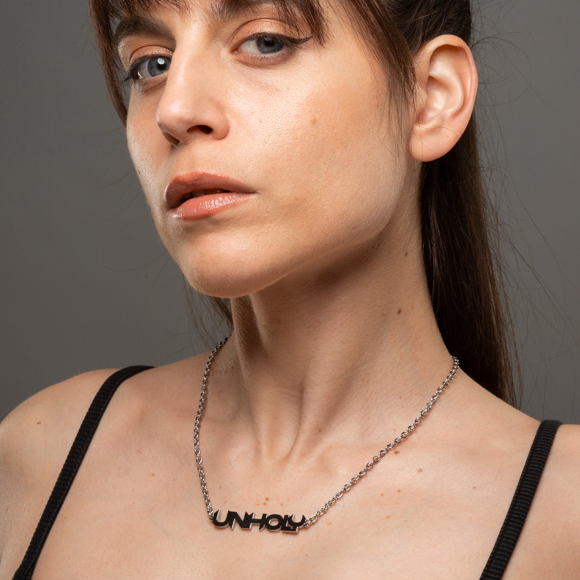 Alternative Gothic Unholy word pendant necklace on silver cable chain
