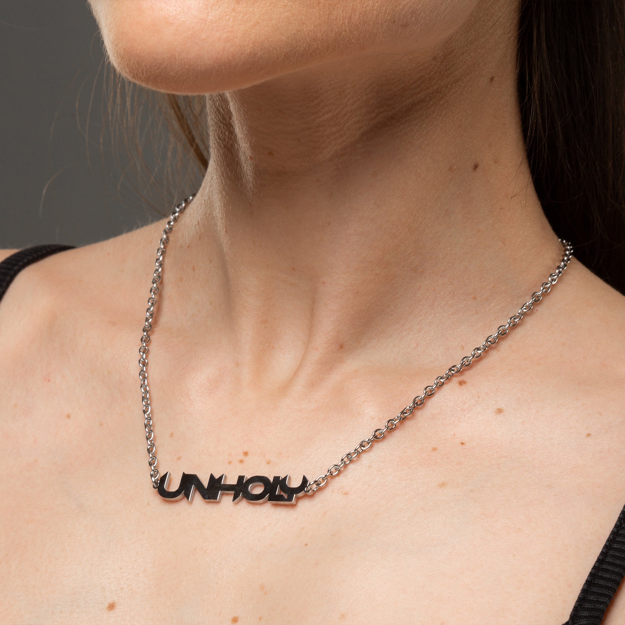 Alternative Gothic Unholy word pendant necklace on silver cable chain