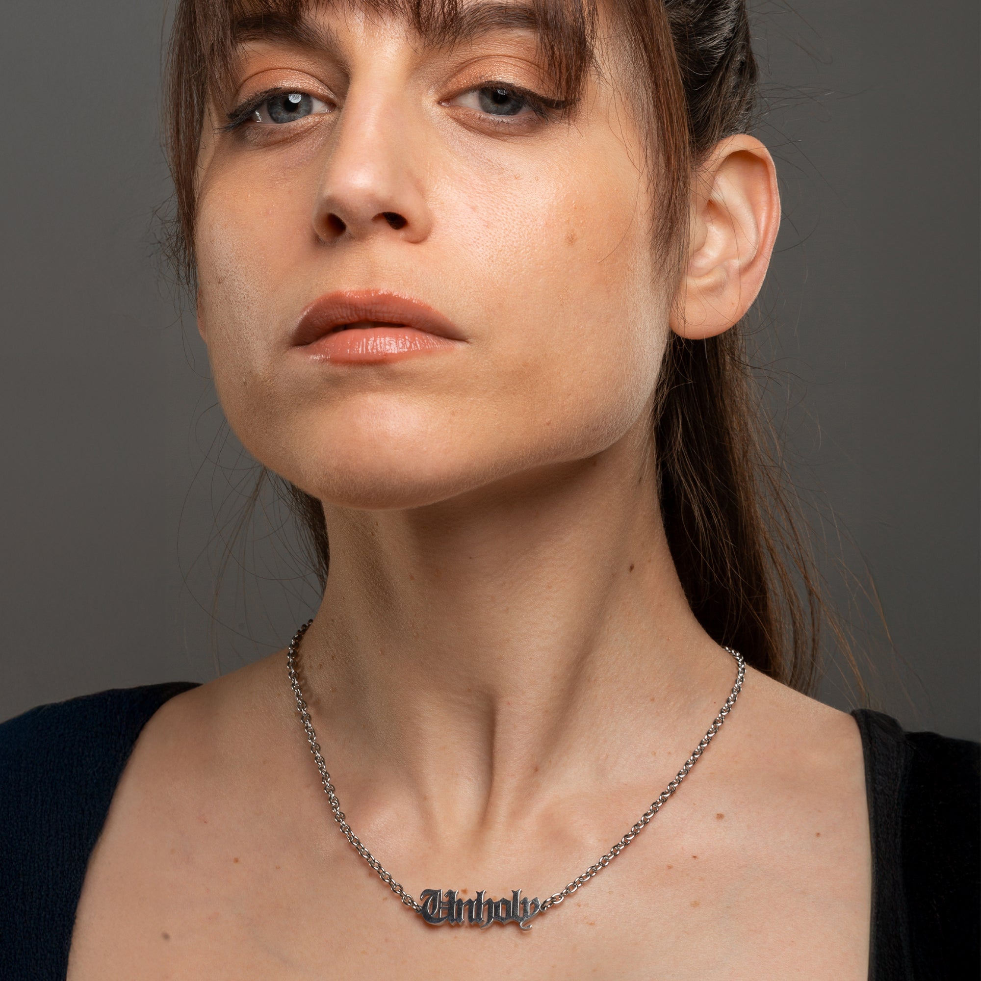 Gothic font Unholy word pendant on silver cable chain