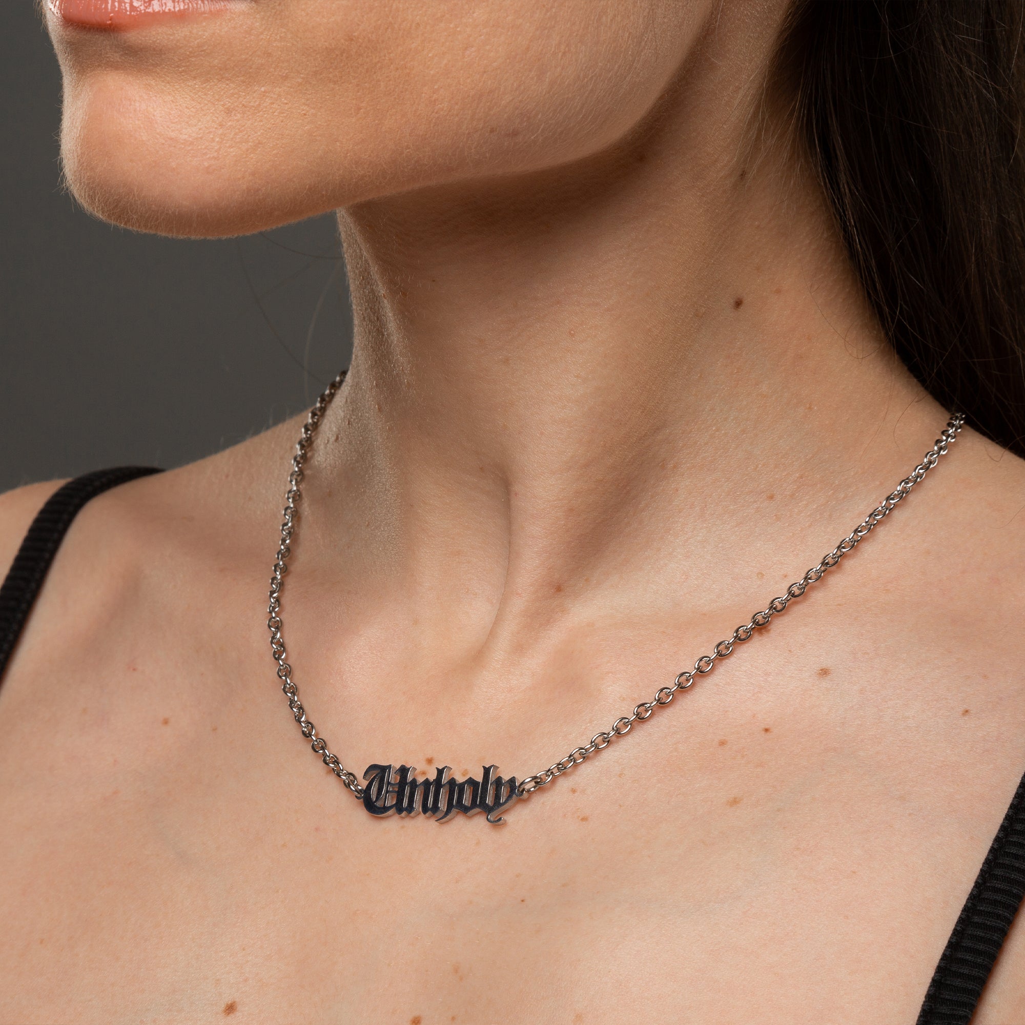 Gothic font Unholy word pendant on silver cable chain