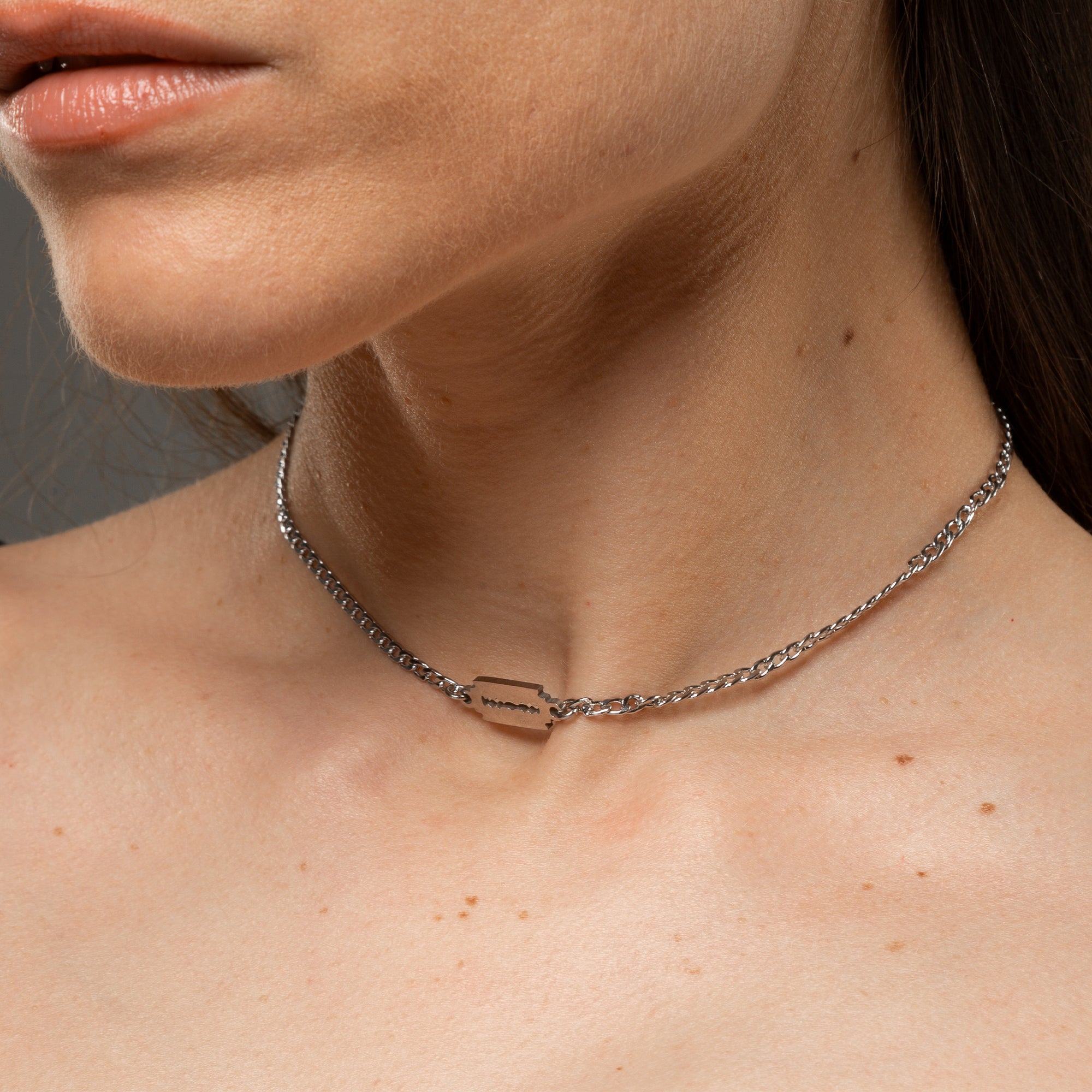 dainty razor blade pendant on a cuban link chain choker in silver