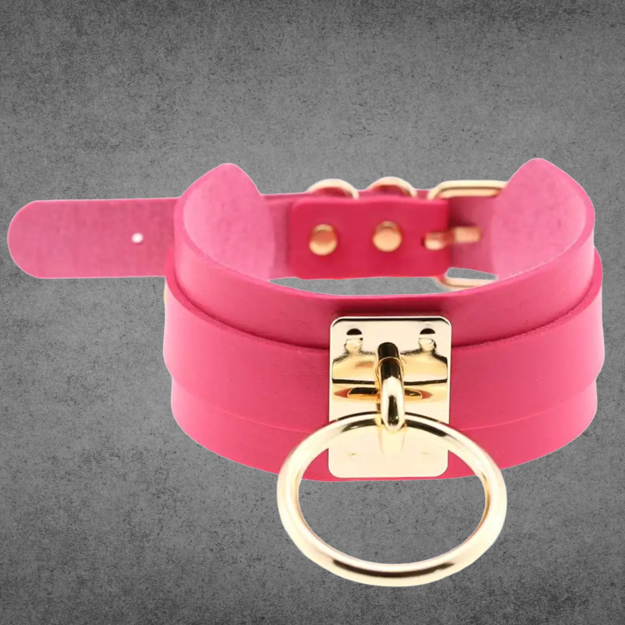 Hot pink faux leather collar with a large gold O-ring centrepiece