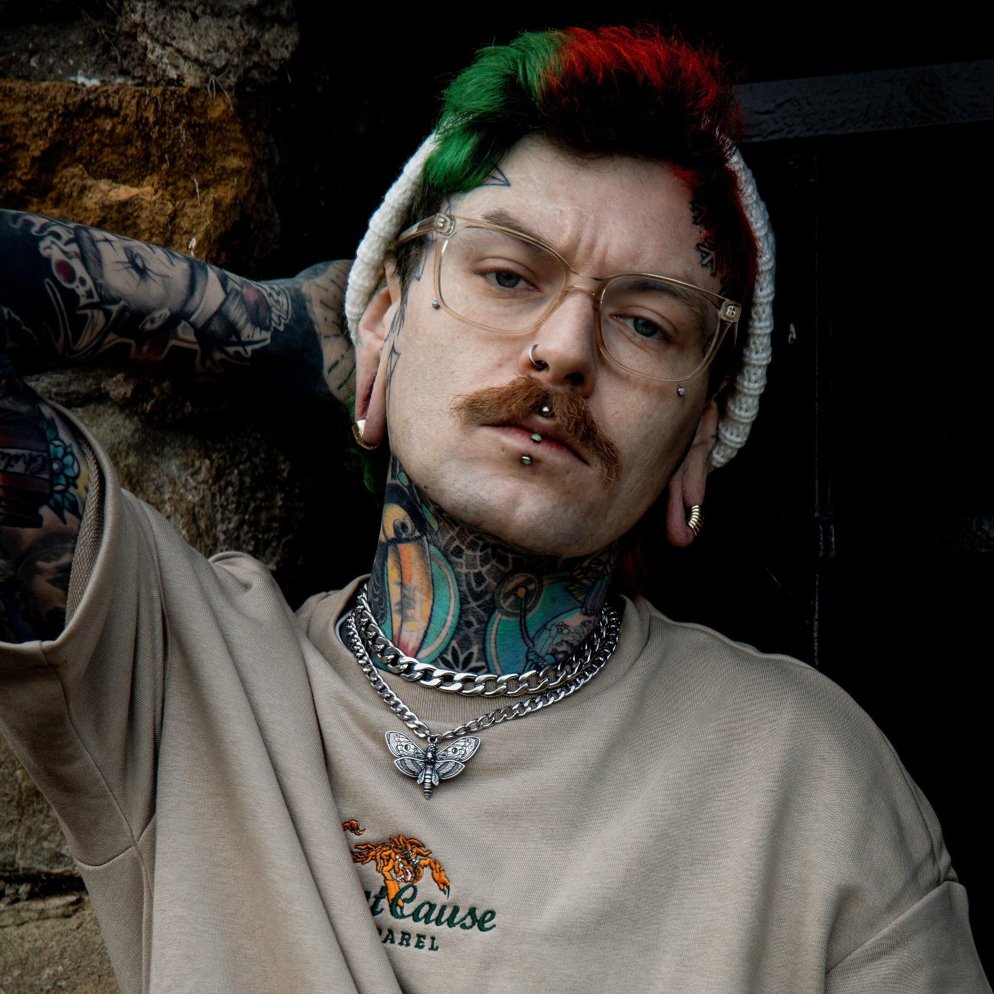 Man wearing a Death Moth Choker with layered silver chunky cuban link choker necklace 