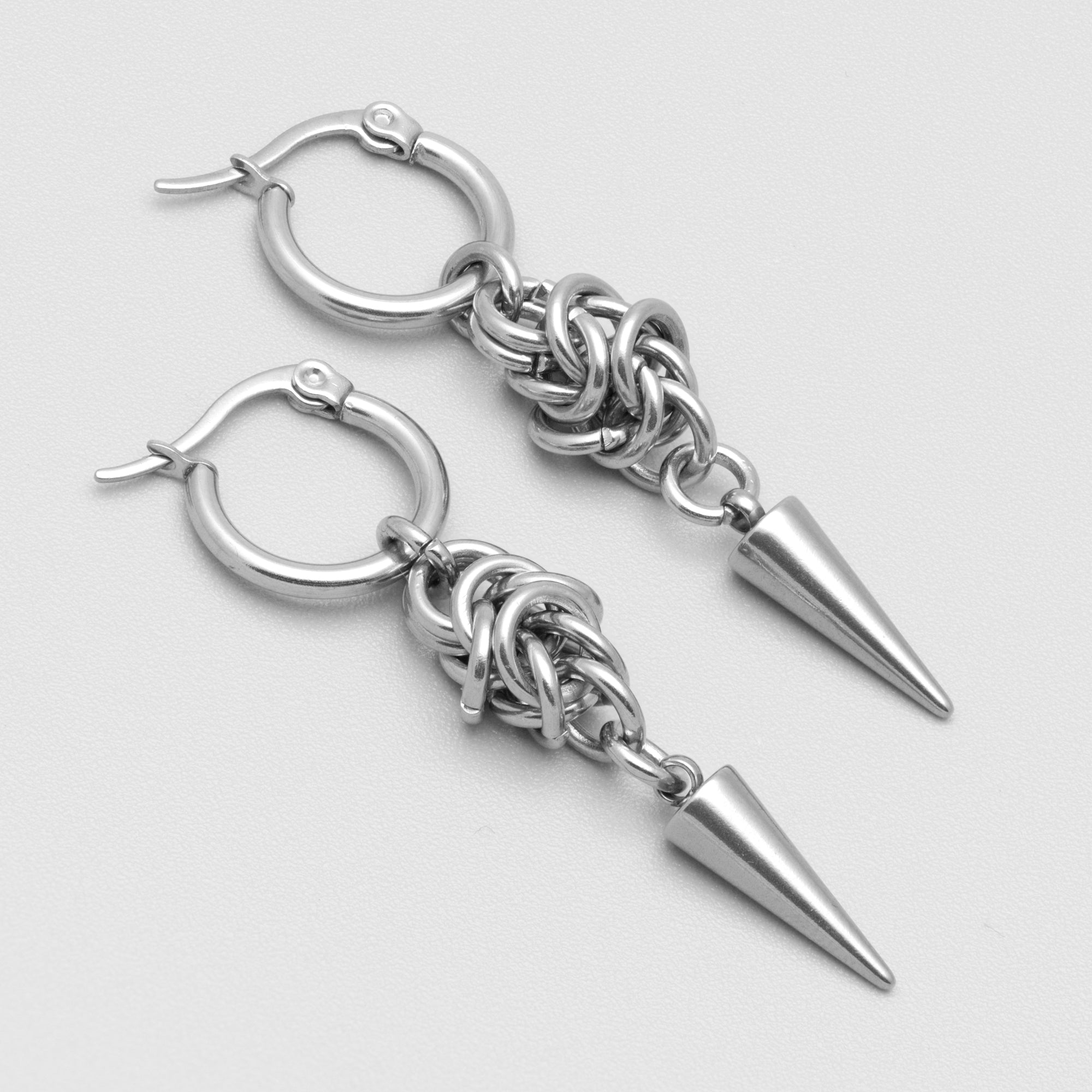 Medieval chainmail hoop earrings featuring a single silver spike 