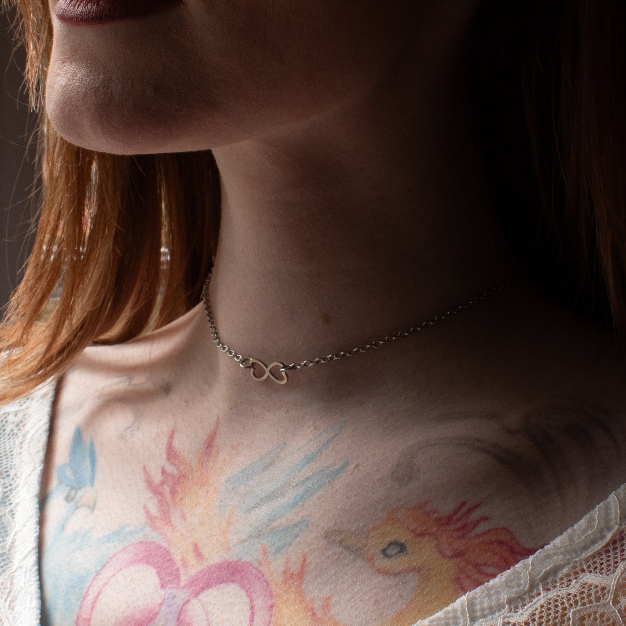 Model wears dainty infinity symbol day collar, worn by model