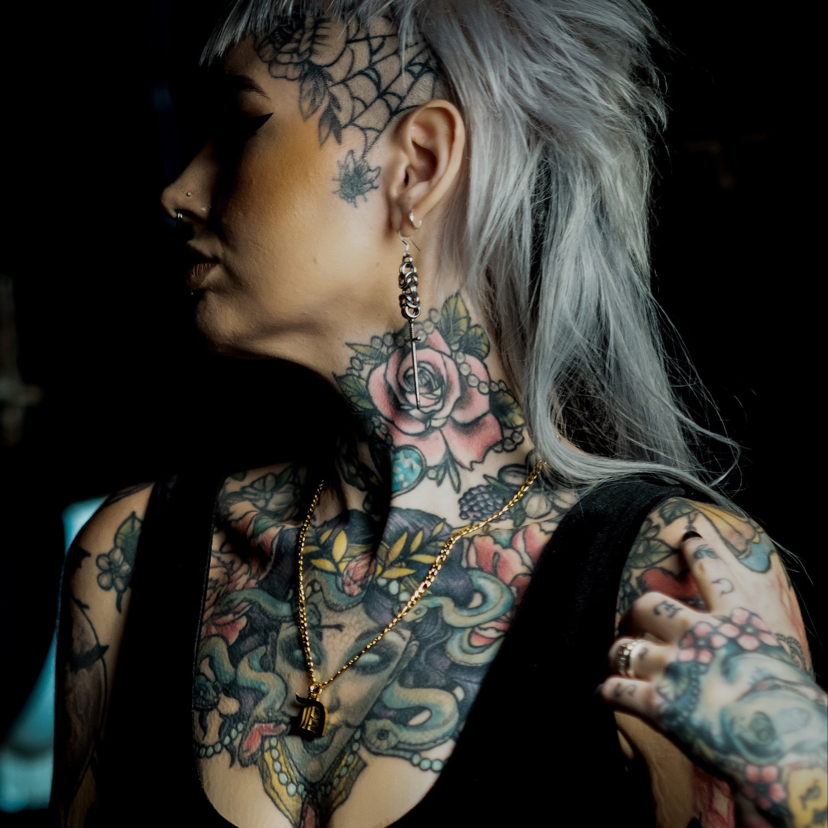 Female model wearing a gold initial necklace 