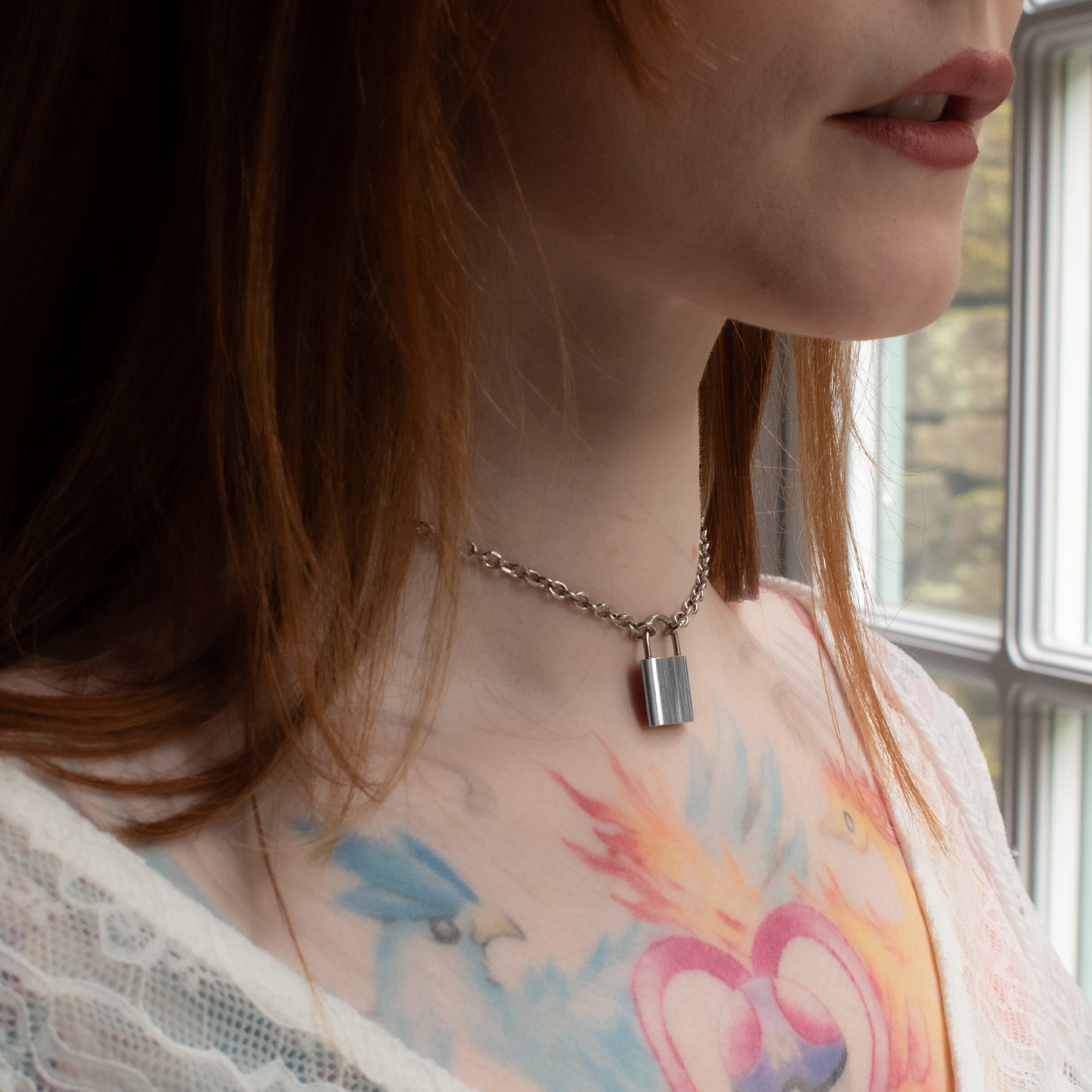 model with red hair and tattoos wears a 25mm large stainless steel padlock pendant day collar necklace