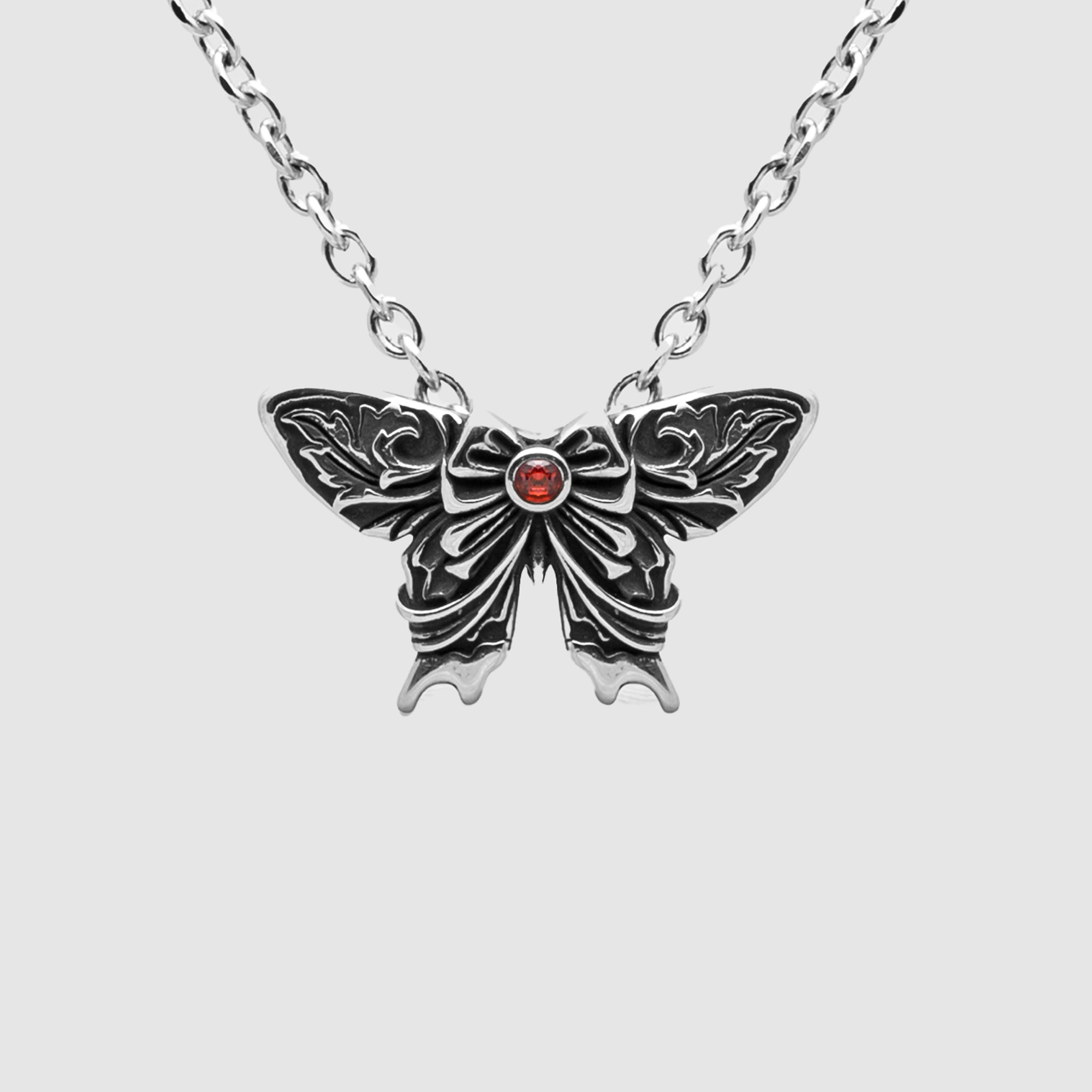 silver Gothic moth pendant featuring a red gemstone on a silver cable chain necklace