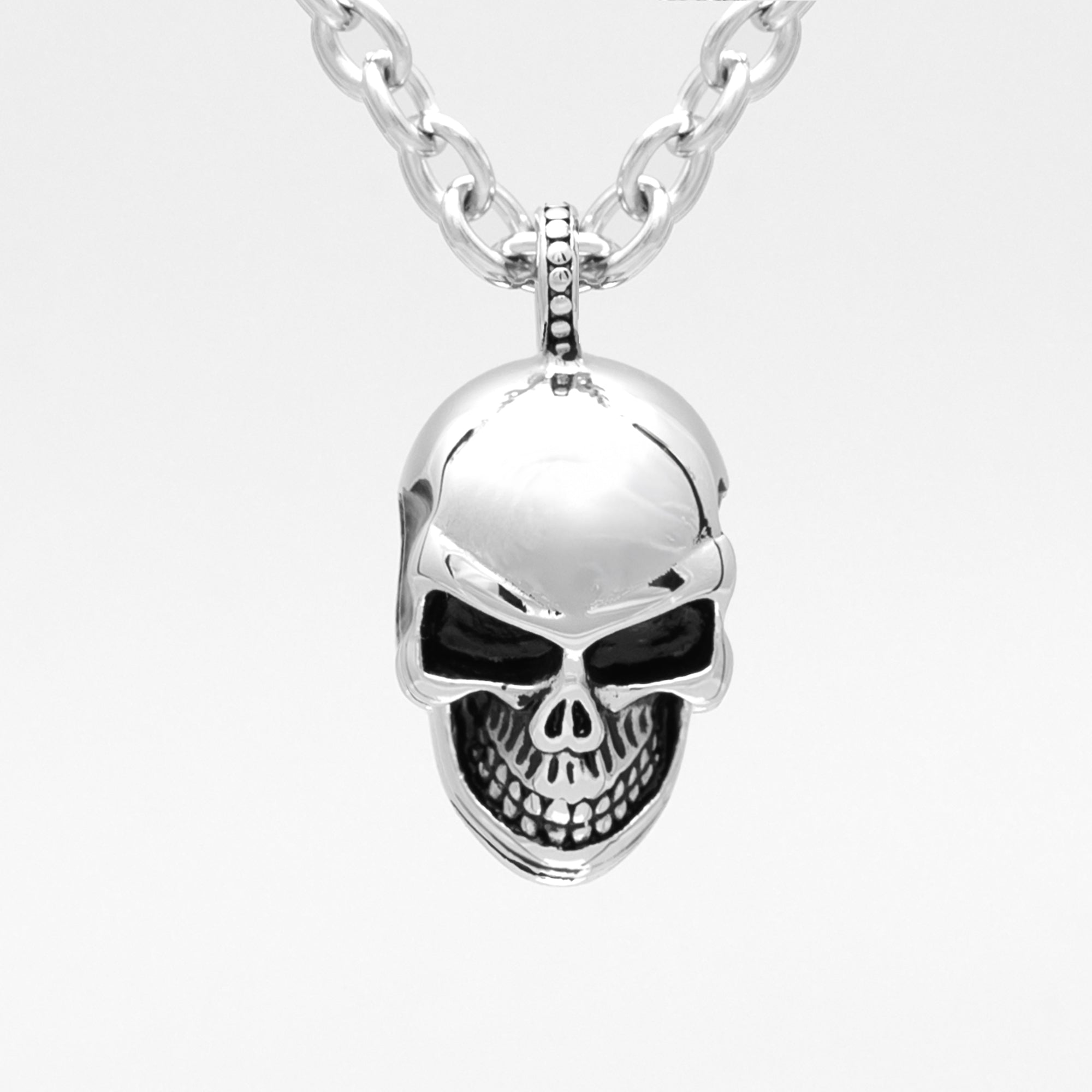 Large silver anatomical skull pendant on a chunky cable chain necklace