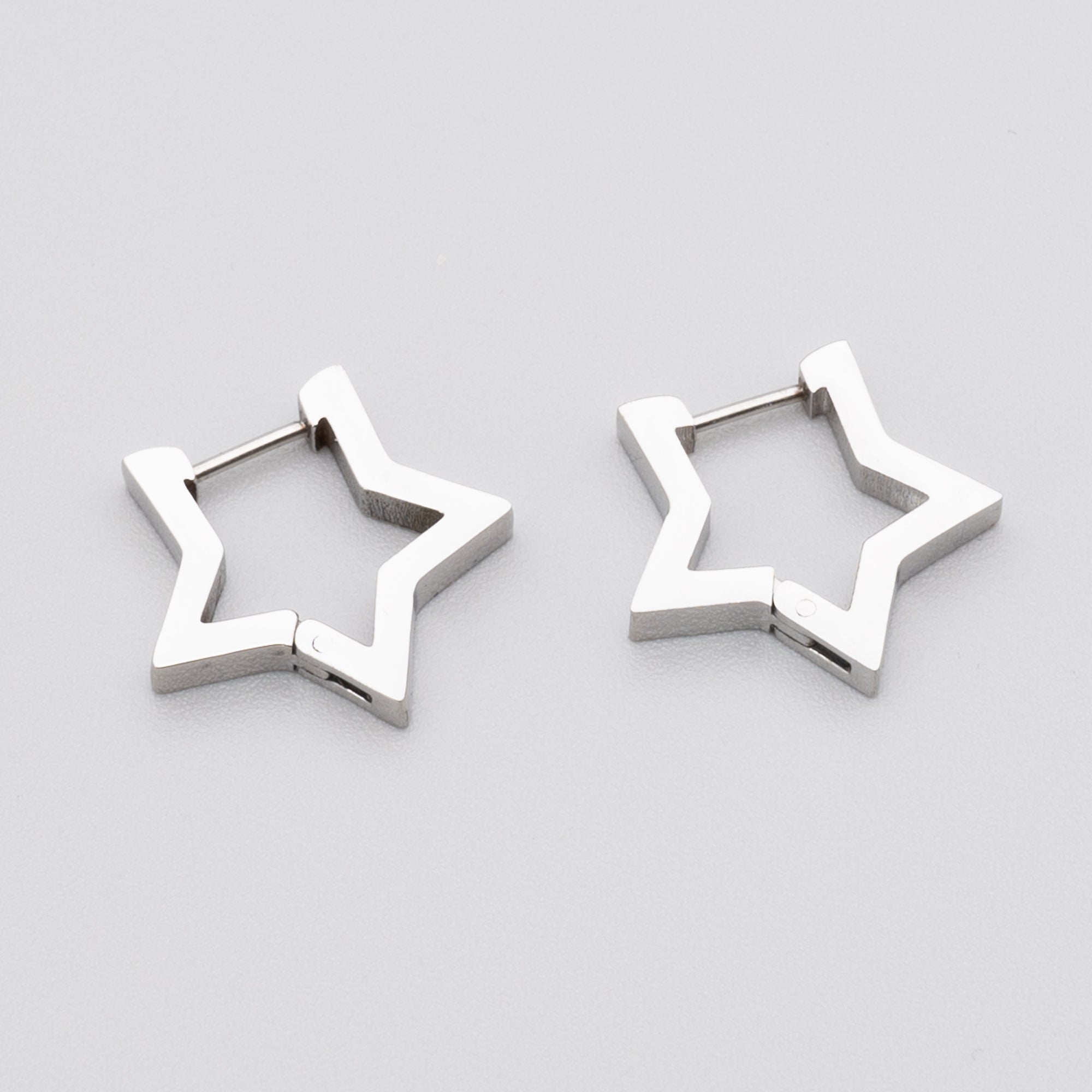 Gothic star shaped huggie hoop earrings in silver